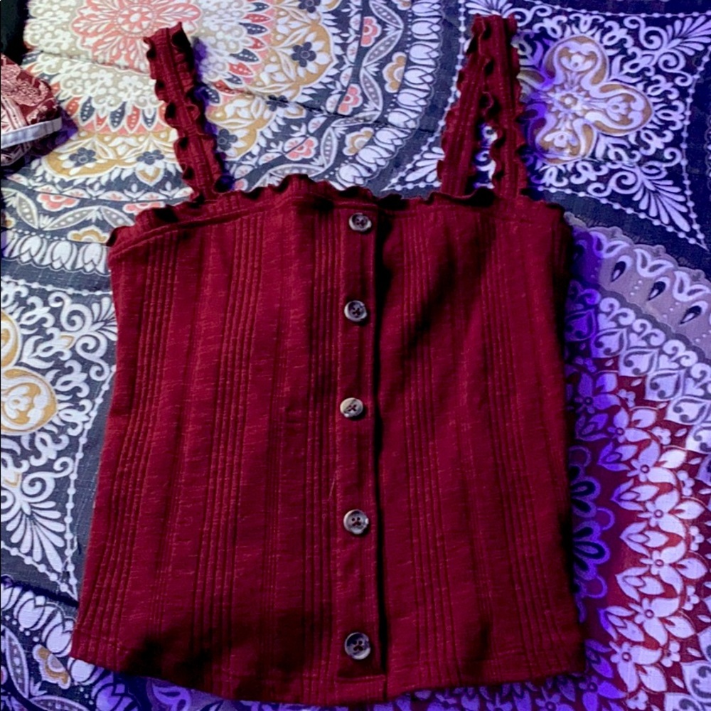 A burgundy, semi cropped with buttons going down.